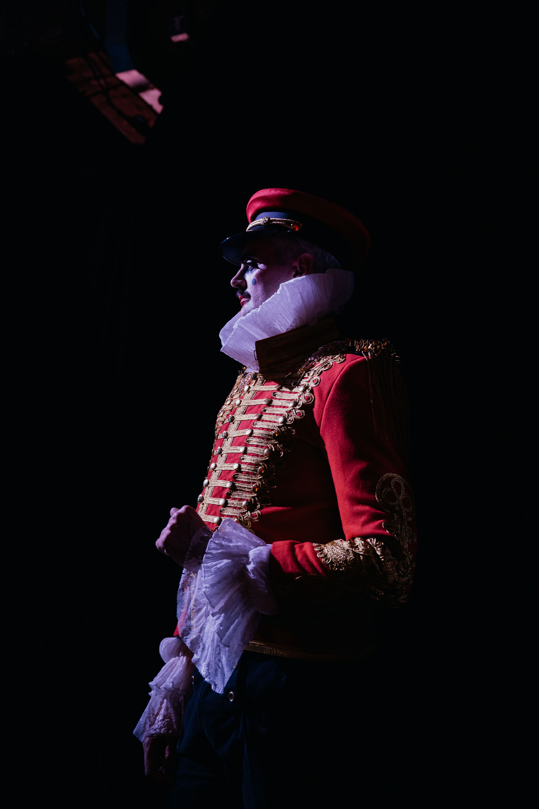 Red military jacket silhouette in spotlight